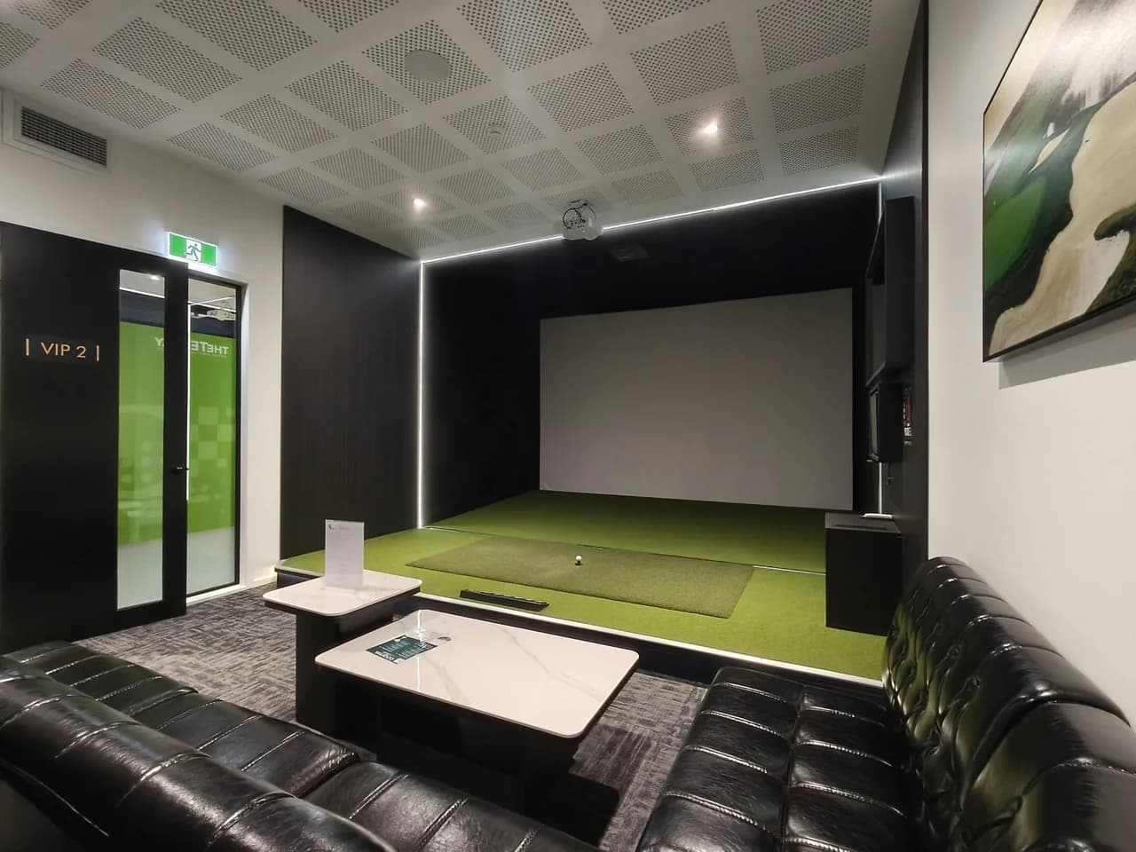 VIP Room 2 at The Tee Bay with a golf simulator and lounge seating