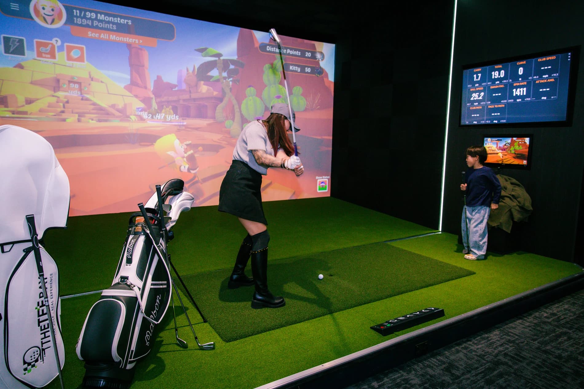 Guests enjoying a TrackMan golf game at The Tee Bay in Botany, East Auckland