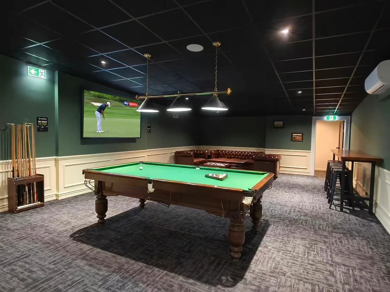 Pool table, television and seating in The Tee Bay Premium Lounge