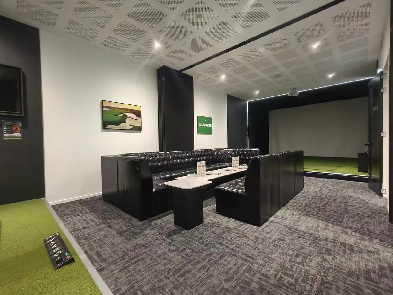 Joined VIP Rooms 1 and 2 at The Tee Bay with shared lounge seating and golf simulator areas